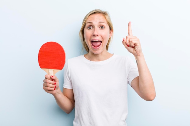 Pretty blonde young adult woman ping pong concept