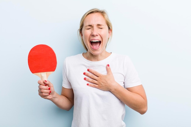 Pretty blonde young adult woman ping pong concept