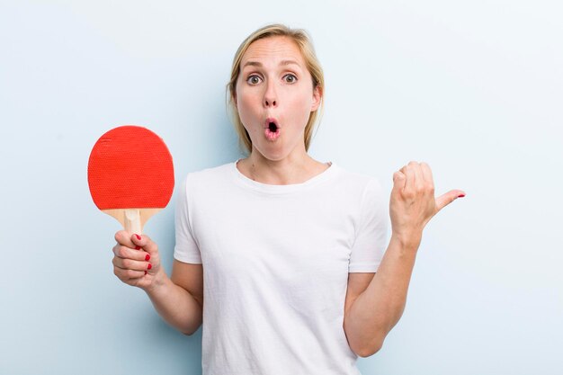 Pretty blonde young adult woman ping pong concept