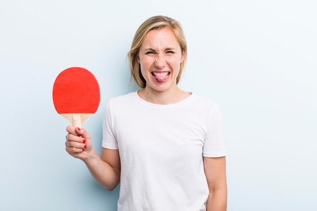 Pretty blonde young adult woman ping pong concept