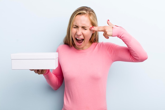 Pretty blonde young adult woman with a take away pizza box