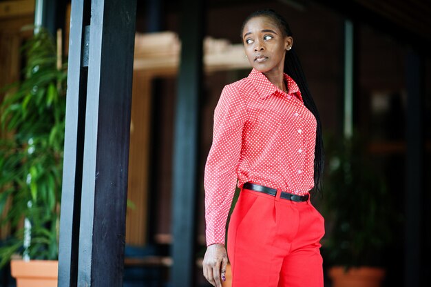 Pretty braids business african american lady bright bossy person friendly wear office red shirt and trousers.