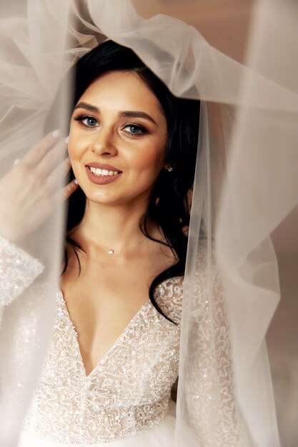 Pretty bride posing with her veil