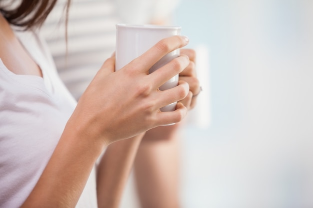 Pretty brunette holding a cup of coffee