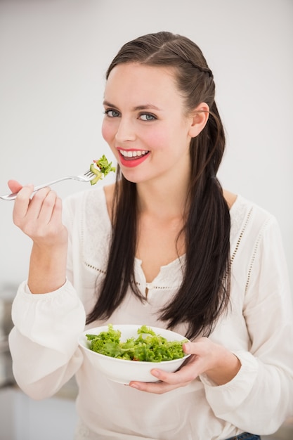 Pretty brunette preparing a healthy salad