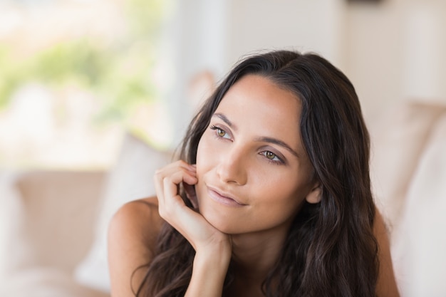 Pretty brunette relaxing on the couch 