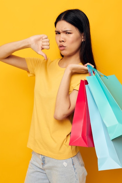 Pretty brunette woman with packages in hands shopping isolated background unaltered