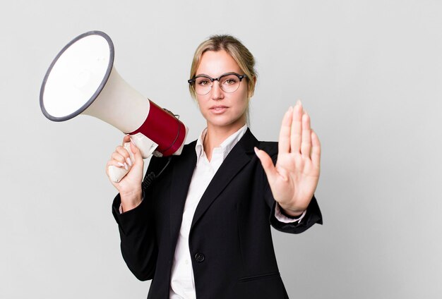 Pretty caucasian business blonde woman with a megaphone