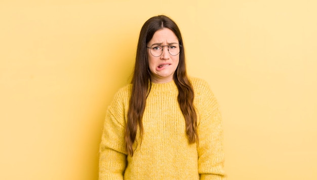 Pretty caucasian woman feeling clueless confused and uncertain about which option to pick trying to solve the problem