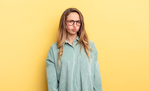 Pretty caucasian woman feeling confused and doubtful, wondering or trying to choose or make a decision