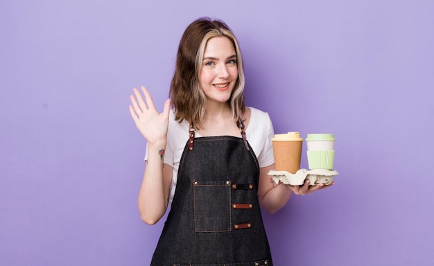 Pretty caucasian woman smiling happily waving hand welcoming and greeting you take away coffee concept