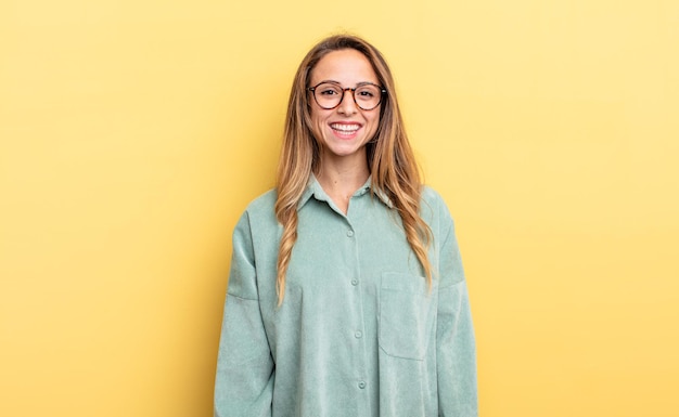 Pretty caucasian woman with a big, friendly, carefree smile, looking positive, relaxed and happy, chilling