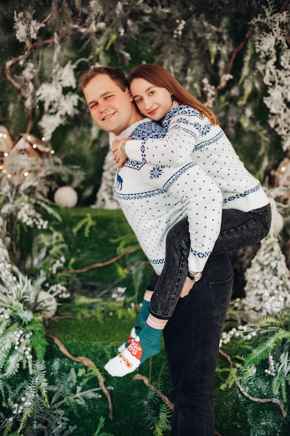 pretty caucasian woman with her husband rejoice together with Christmas decorations