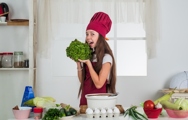 Pretty child eating fresh salad, healthy food.