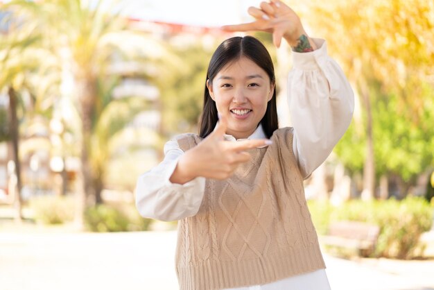 Pretty Chinese woman at outdoors With happy expression