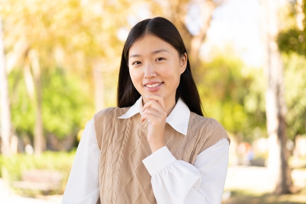 Pretty Chinese woman at outdoors With happy expression