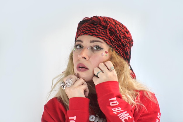 Pretty cute arab smiling woman in red shirt boho hippie style with accessories posing