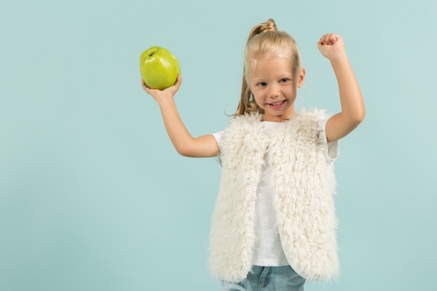 Pretty, cute girl in light clothes hold apples