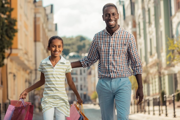 Pretty cute girl walking with her daddy