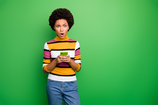  of pretty dark skin curly lady holding telephone hands reading awful fake news unbelievable epic failure wear casual striped pullover jeans 