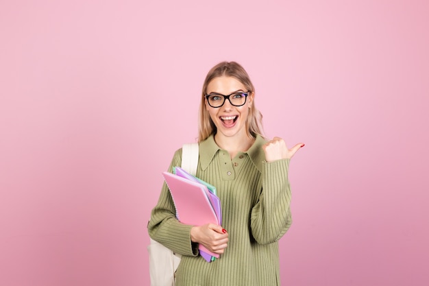 Pretty european woman in casual sweater on pink wall