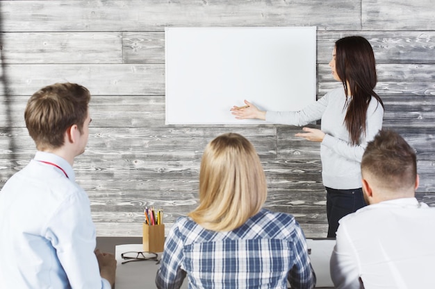 Pretty female showing whiteboard