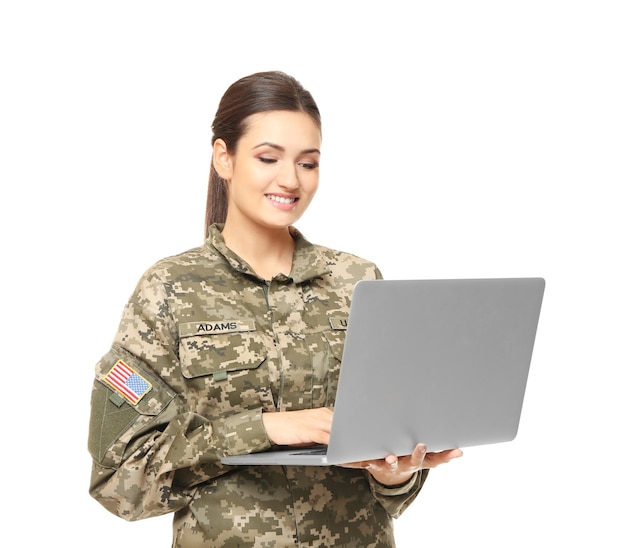 Pretty female soldier with laptop on white background