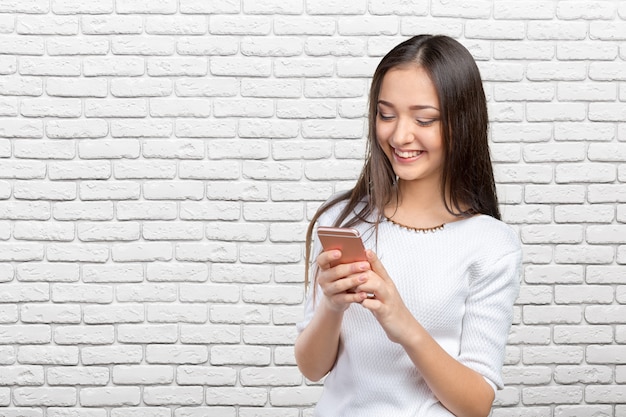 Pretty female teenager using smartphone 