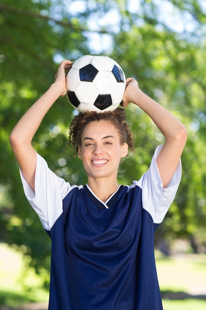 Pretty football player smiling at camera