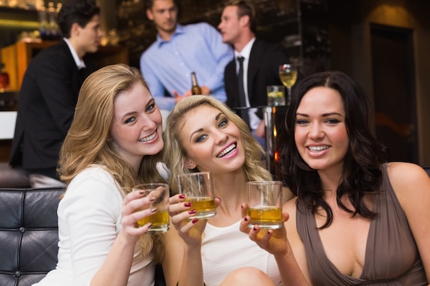 Pretty friends having a drink together