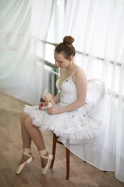 Pretty girl ballet dancer practicing indoor