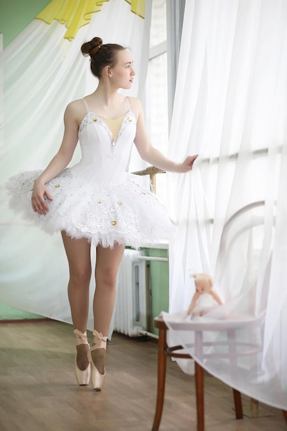 Pretty girl ballet dancer practicing indoor