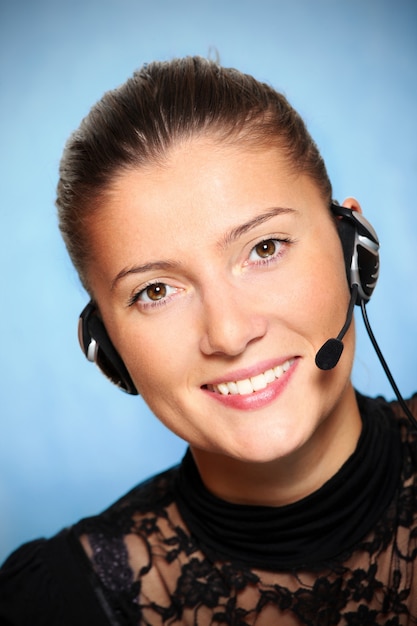 a pretty girl in the call center over blue background