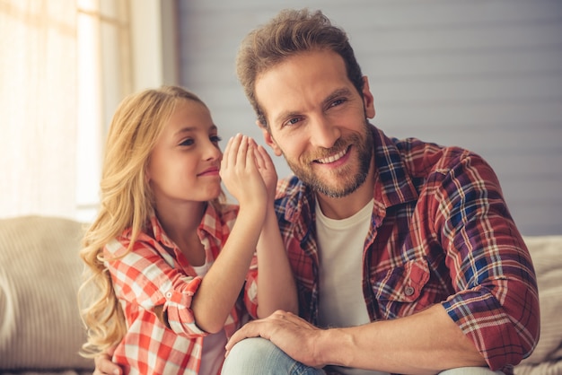 Pretty girl is whispering to her father