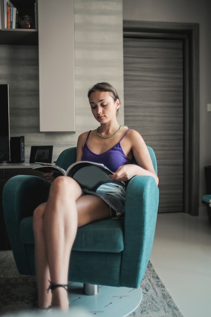 Pretty girl reading a magazine