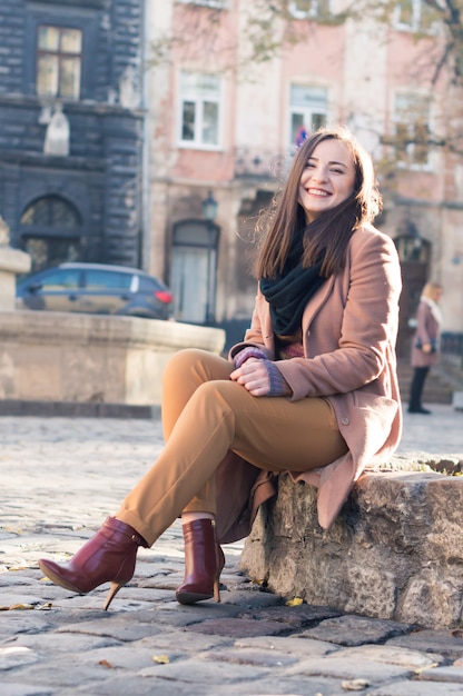 Pretty girl sits on a rock