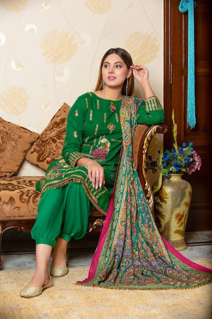 Pretty Girl Sitting on Sofa for Traditional Photoshoot Wearing Desi Dress