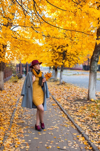 Pretty girl walking in the autumn city