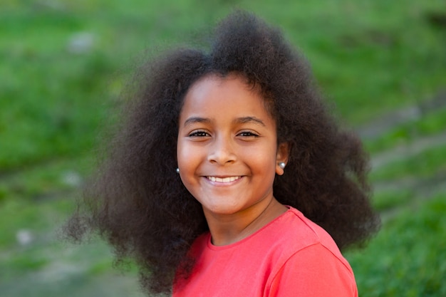 Pretty girl with long afro hair in the garden 