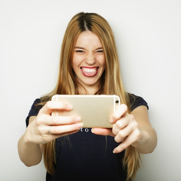 Pretty hipster girl taking selfie. Young and happy.