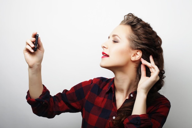 Pretty hipster girl taking selfie Young and happy