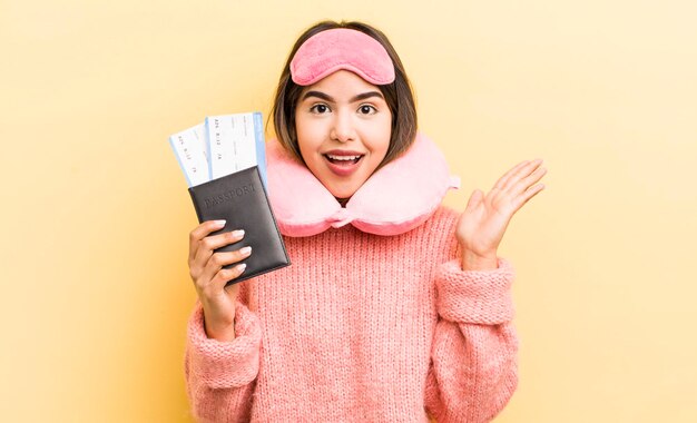 Pretty hispanic girl feeling happy and astonished at something unbelievable flight passenger concept