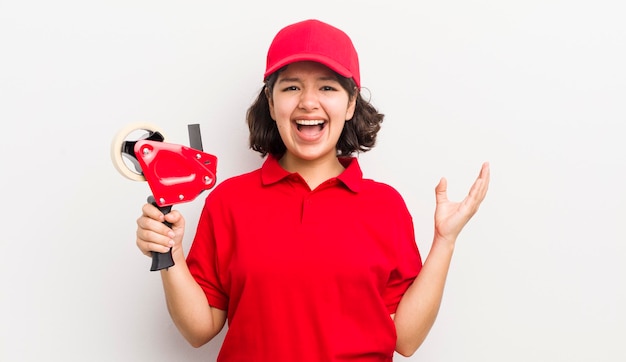 Pretty hispanic girl feeling happy and astonished at something unbelievable packer concept