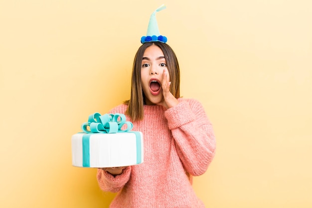 Pretty hispanic girl feeling happygiving a big shout out with hands next to mouth birthday concept