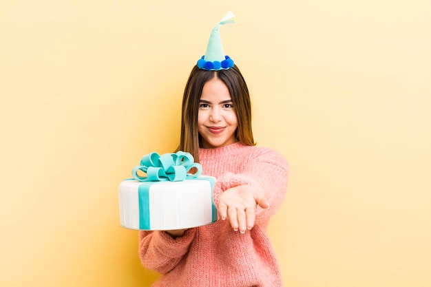 Pretty hispanic girl smiling happily with friendly and offering and showing a concept birthday concept