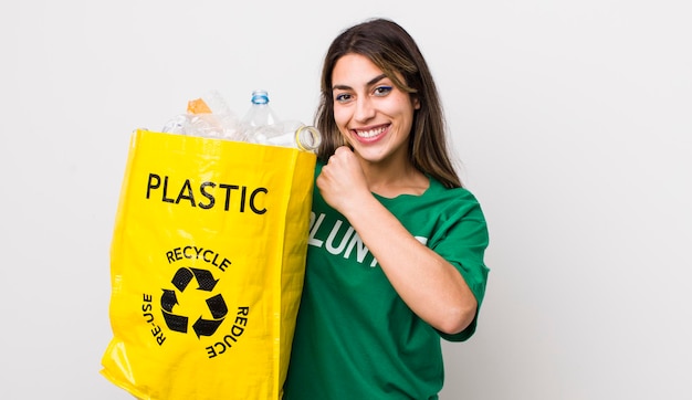 Pretty hispanic woman feeling happy and facing a challenge or celebrating ecology concept