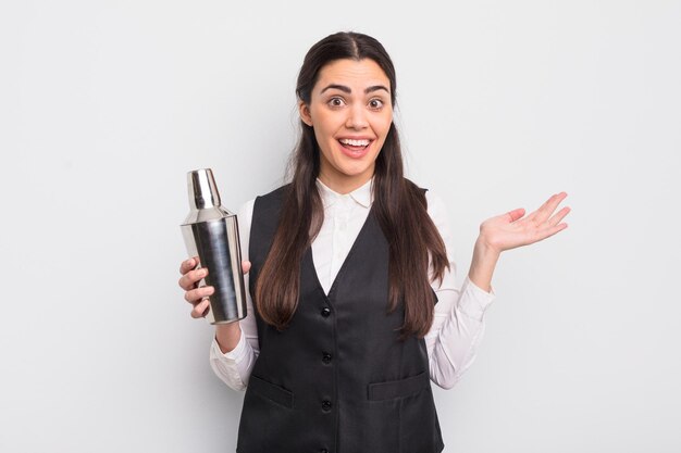 Pretty hispanic woman feeling happy surprised realizing a solution or idea barman cocktail concept