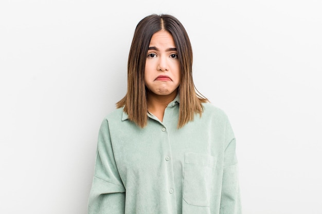 Pretty hispanic woman feeling sad and stressed upset because of a bad surprise with a negative anxious look