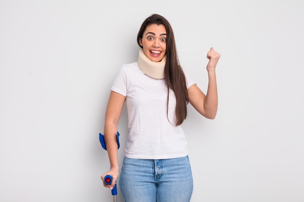 Pretty hispanic woman feeling shockedlaughing and celebrating success crash and physical injury concept