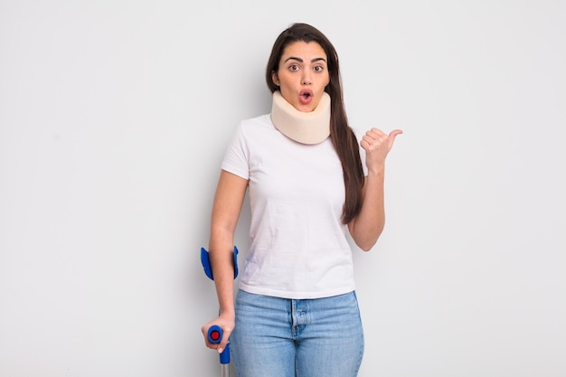 Pretty hispanic woman looking astonished in disbelief. crash and physical injury concept